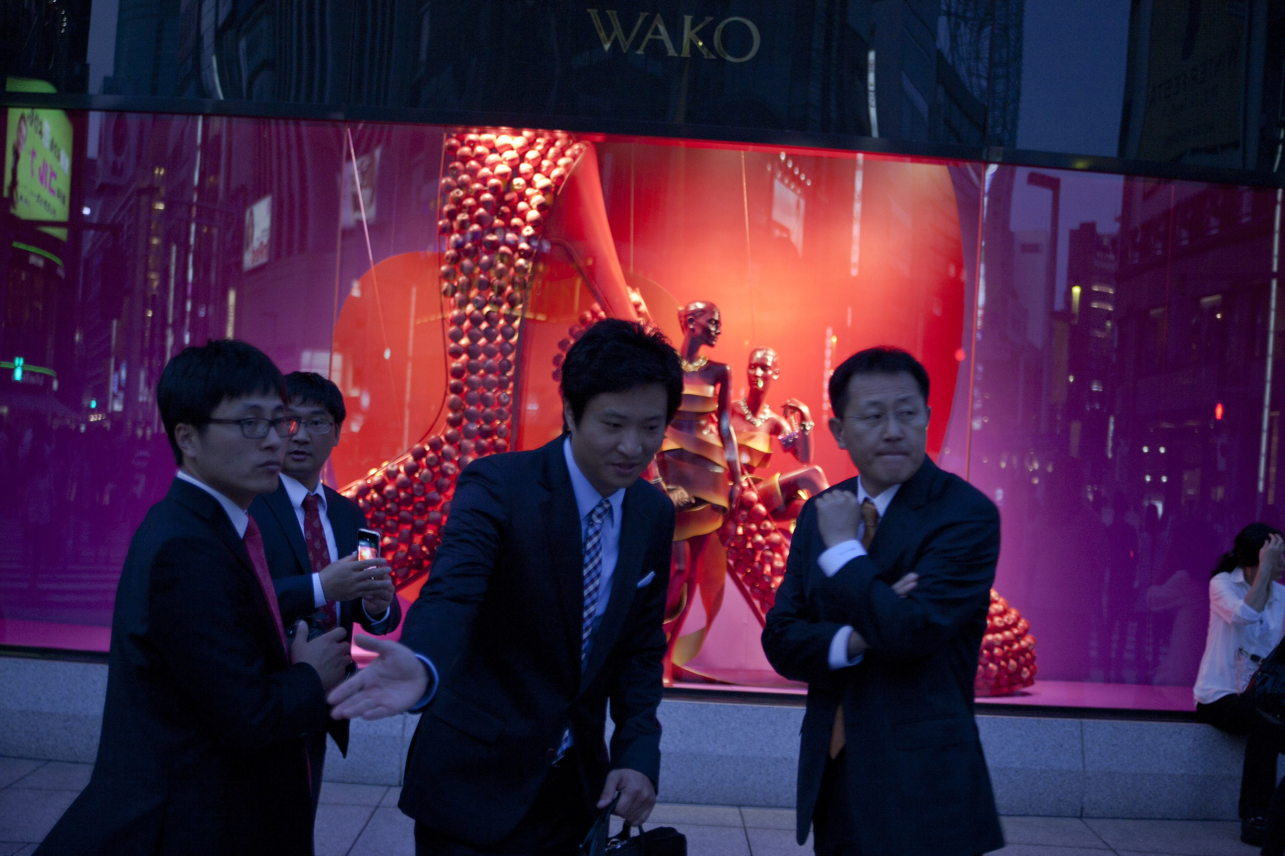 A group of businesmen on the flashy high street Ginza